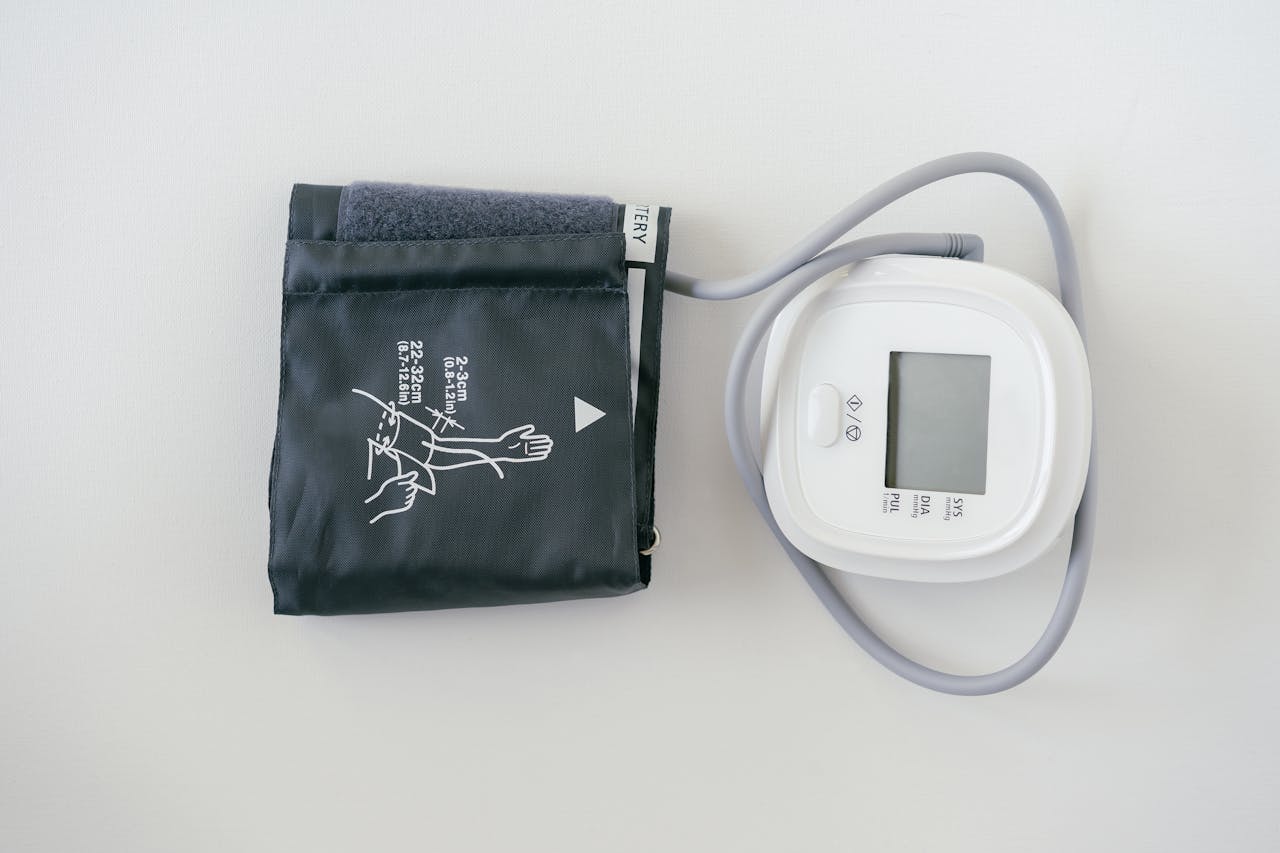 A digital sphygmomanometer on a white background, used for measuring blood pressure.